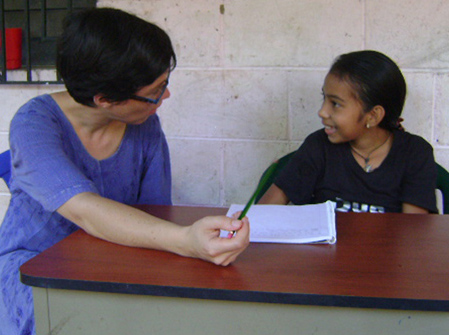 Graduate student Lynnette Arnold working with a student in El Salvador